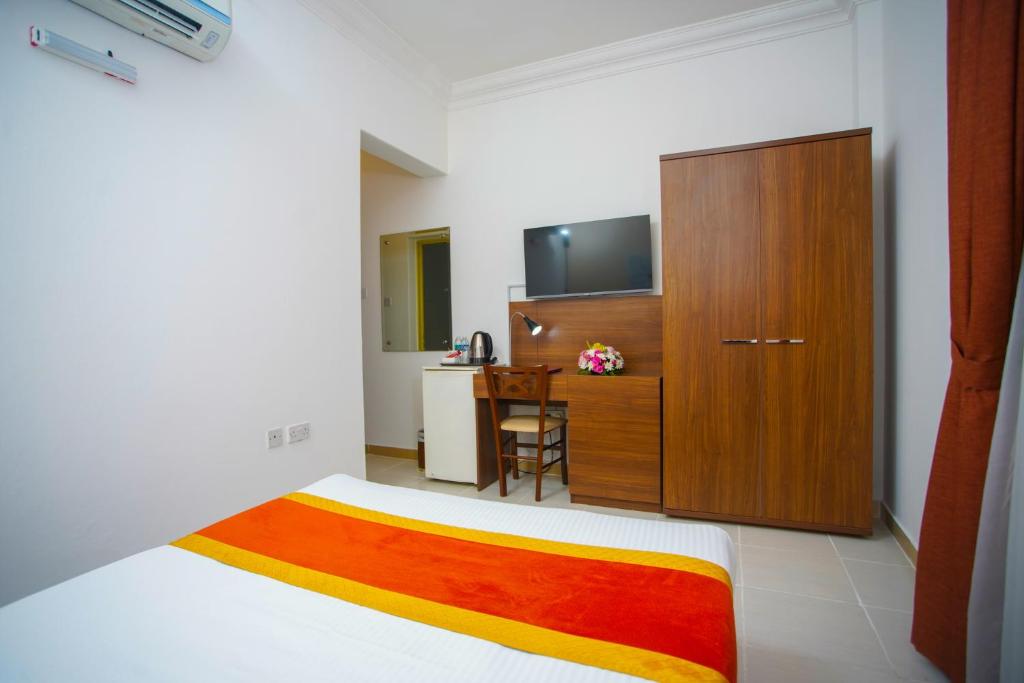 TV a/nebo společenská místnost v ubytování La Villa Palace Hotel