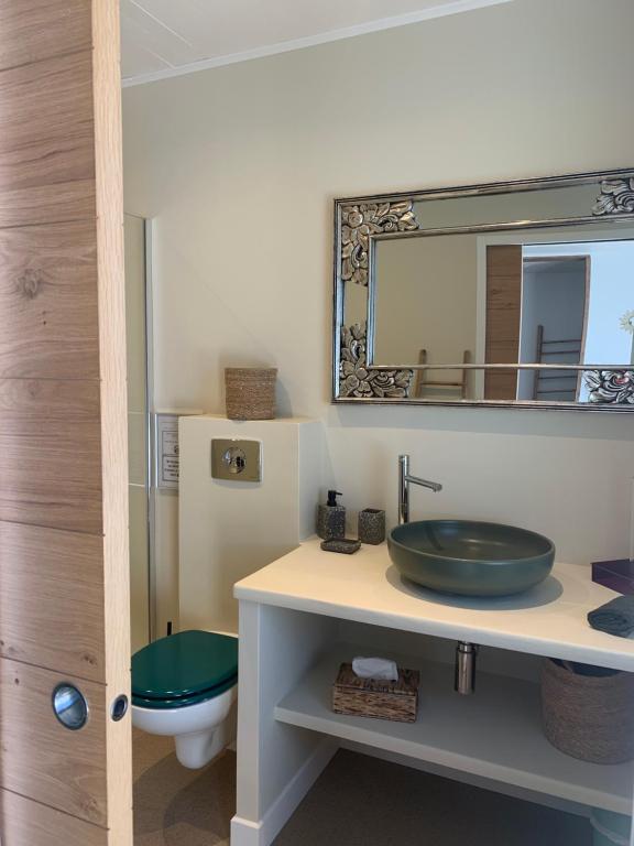 a bathroom with a sink and a mirror at Chambre d'hôtes A Vadina Porticcio in Porticcio