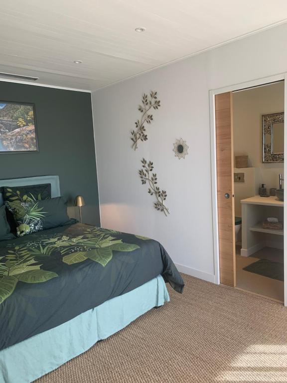 a bedroom with a bed and a door to a room at Chambre d'hôtes A Vadina Porticcio in Porticcio
