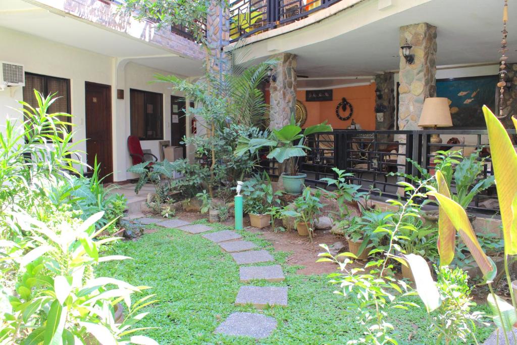 a garden with a walkway in front of a house at Balaibinda Lodge in Coron