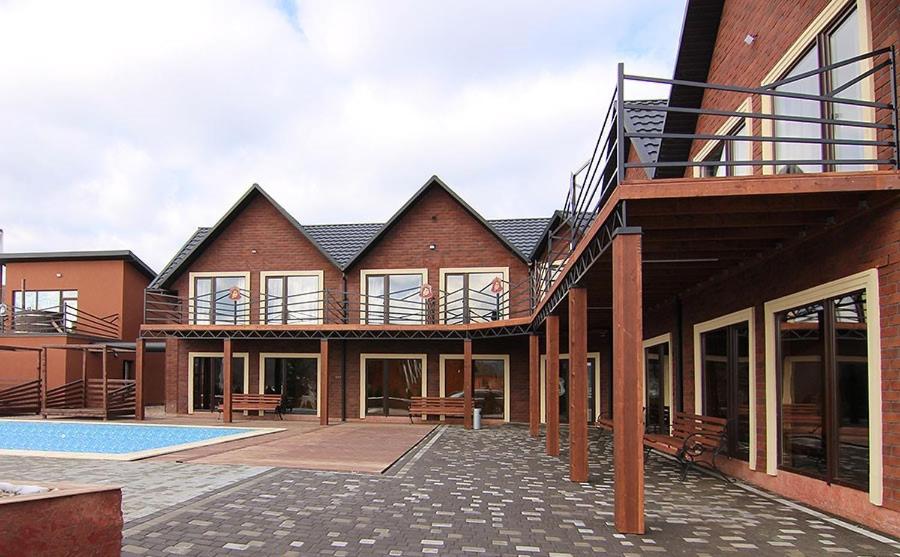 a house with a courtyard with a swimming pool at Four Seasons In Carpathians in Migovo