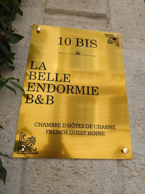 a yellow sign on the side of a building at La Belle Endormie B&B French Guest house in Bordeaux