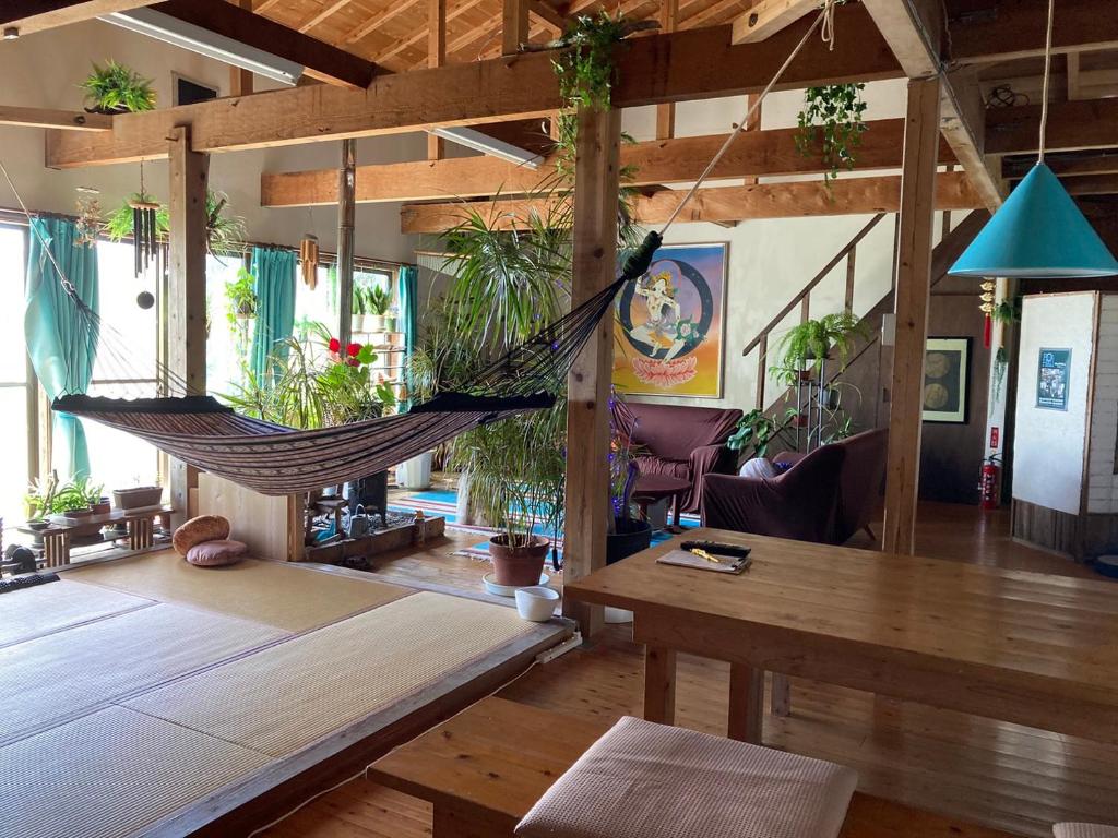a room with a hammock hanging from the ceiling at 銀河荘-Galaxy Guesthouse 12歳以下不可 in Hachijo