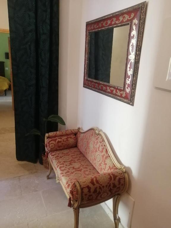 a mirror on a wall next to a couch at Le Tre Terrazze in Bologna