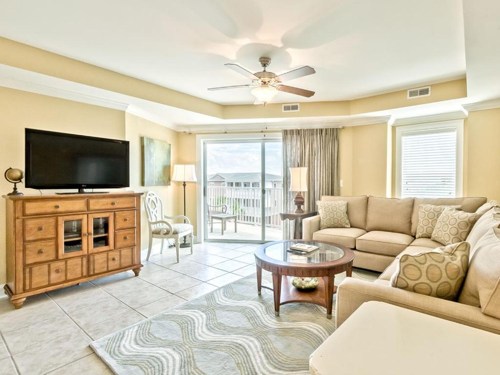 a living room with a couch and a flat screen tv at Gull Reef 635 in Tybee Island