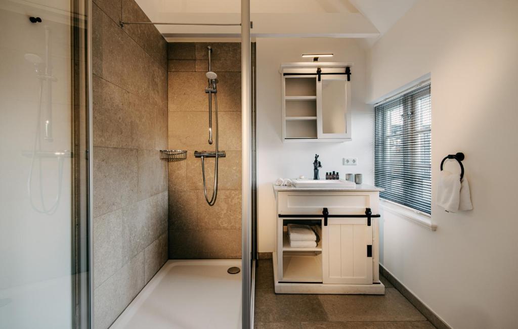 a bathroom with a shower and a sink at Seaside 43 in Sankt Peter-Ording