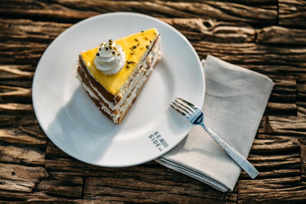 a piece of cake on a plate with a fork at Seaside 43 in Sankt Peter-Ording