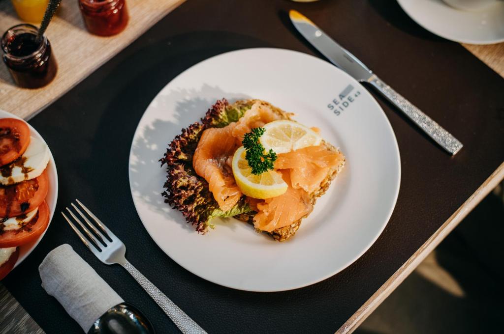 a white plate of food on a table at Seaside 43 in Sankt Peter-Ording