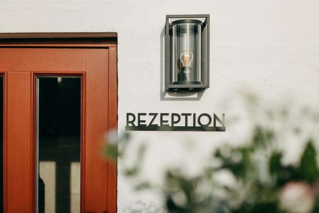 a sign on the side of a building with a light at Seaside 43 in Sankt Peter-Ording