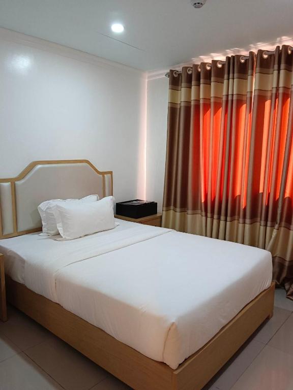 Postel nebo postele na pokoji v ubytování PUNTA CLARK HOTEL