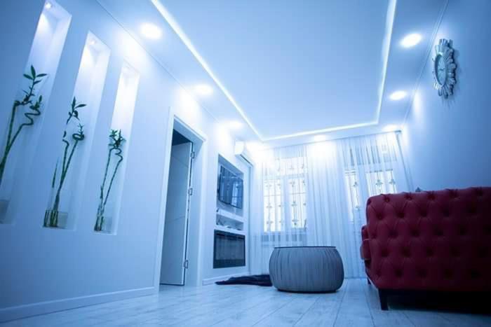 a living room with a red couch and a chair at beautiful and comfortable apartment in the city center in an architectural building in Baku