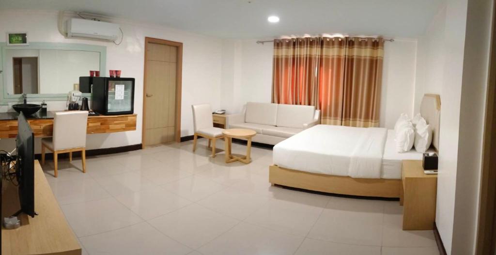 Postel nebo postele na pokoji v ubytování PUNTA CLARK HOTEL