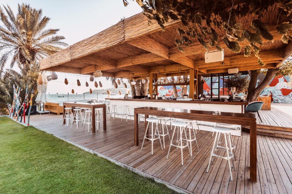 a bar with tables and chairs on a deck at Flamm in Golturkbuku