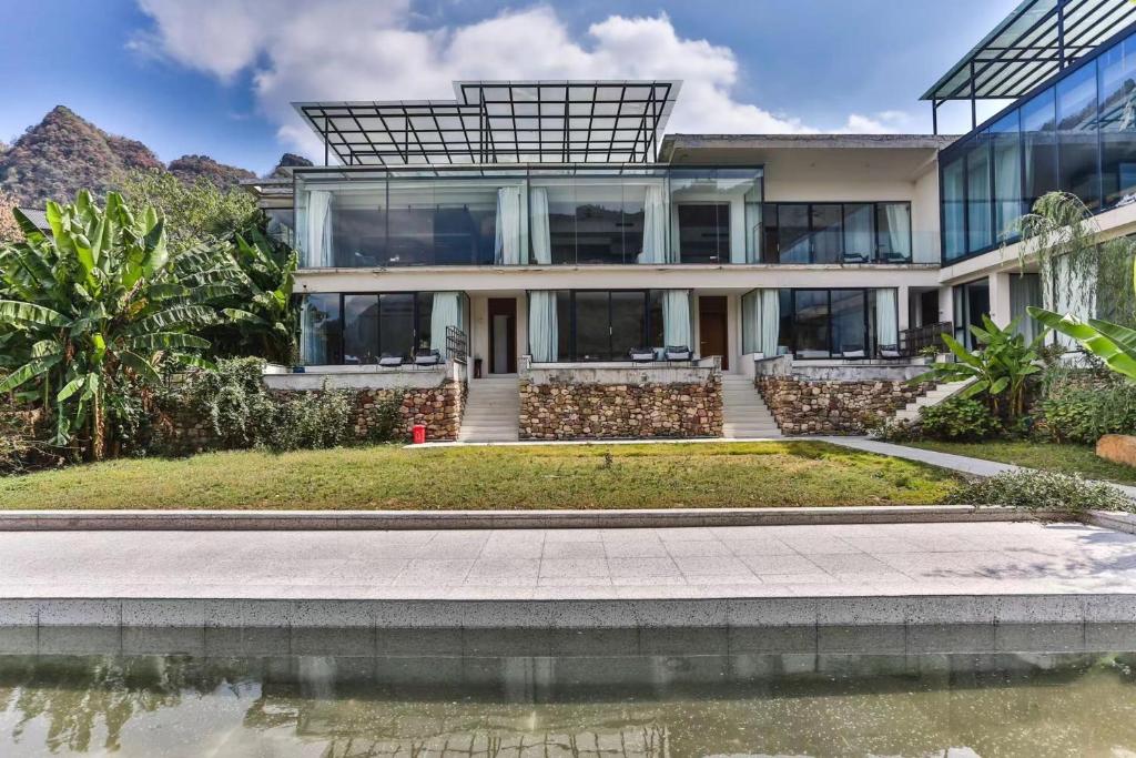 an exterior view of a house with mountains in the background at Purespace in Zhangjiajie