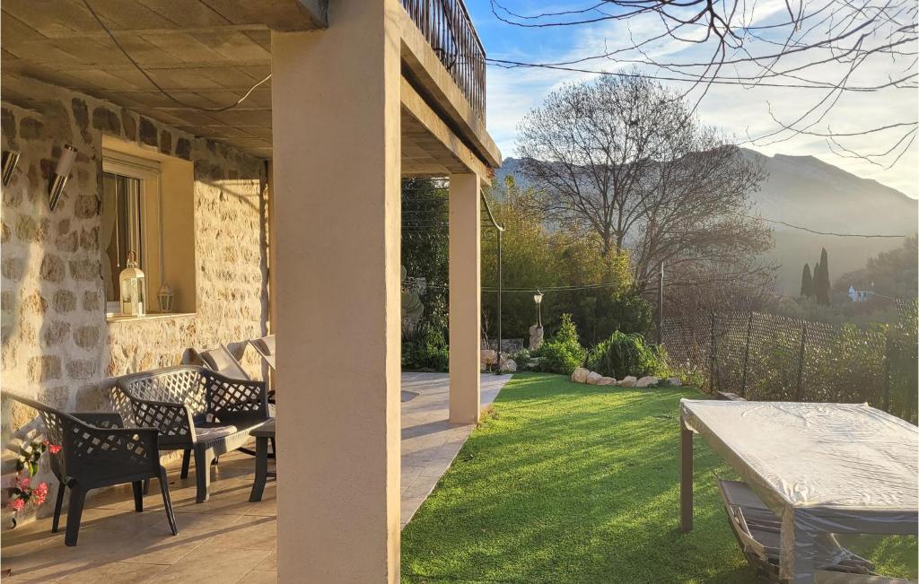 a porch of a house with a table and chairs at 1 Bedroom Cozy Home In Roquevaire in Roquevaire