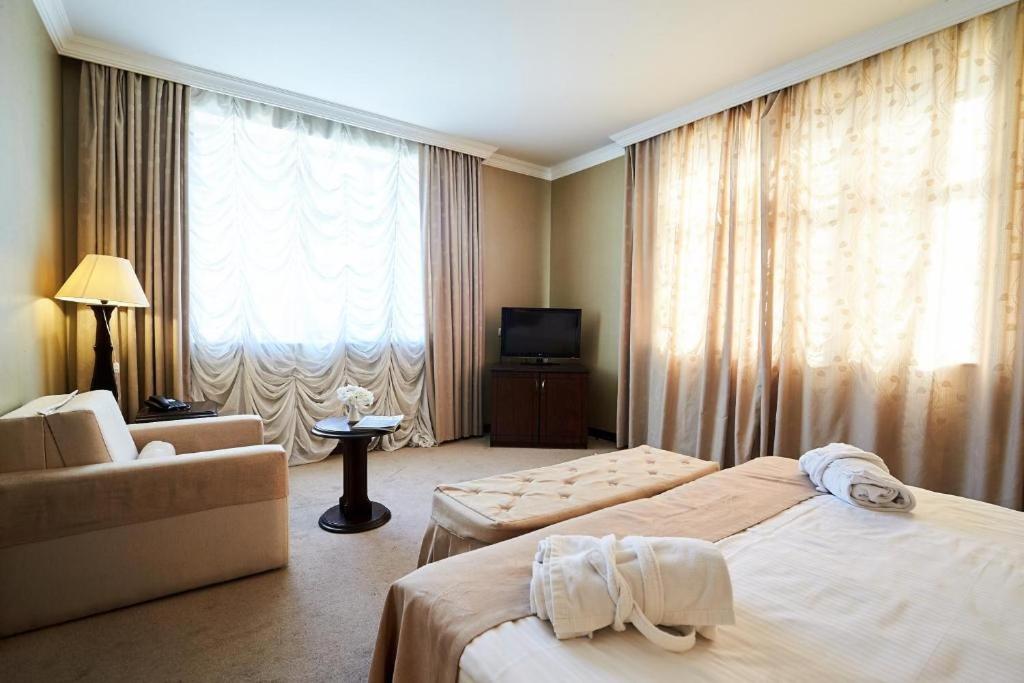 a hotel room with two beds and a television at Smith's Boutique Hotel in Baku