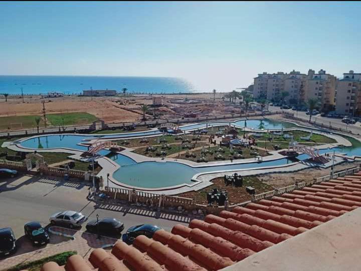 a view of two swimming pools in a city at El Obayed Apartments Armed Forces in Marsa Matruh