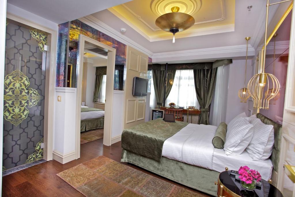 a bedroom with a large bed and a large window at Taksim Star Hotel in Istanbul