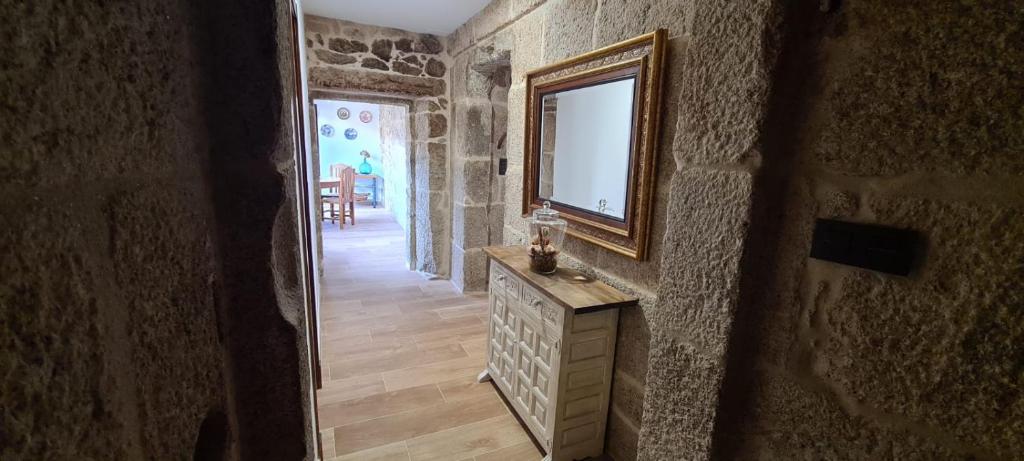 a hallway with a mirror and a dresser in a room at Casa Lisboana in Pontevedra