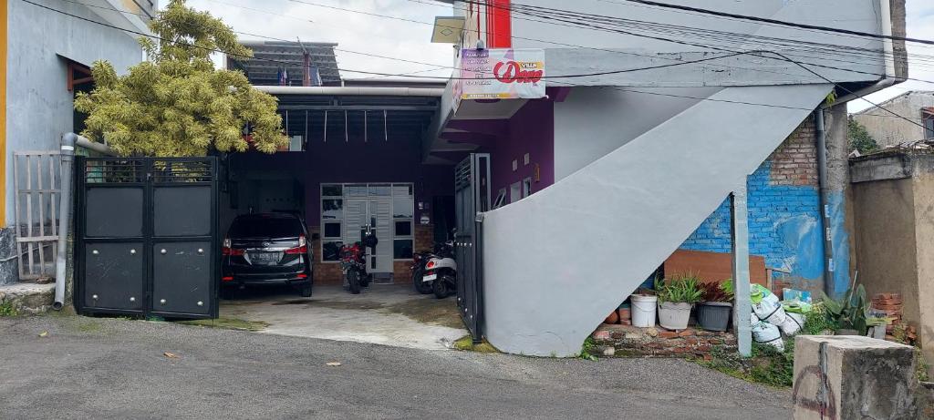 a garage with a motorcycle parked outside of a building at Villa Dono in Pasuruan