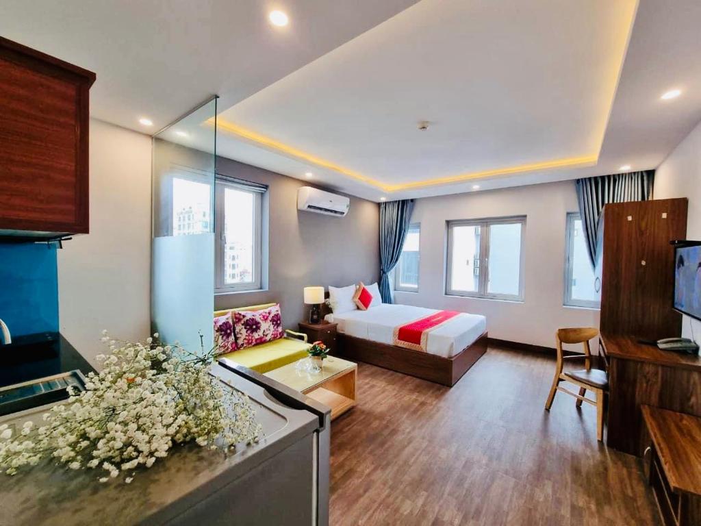 a hotel room with a bed and a living room at Delicate Serviced Apartment And Hotel in Da Nang