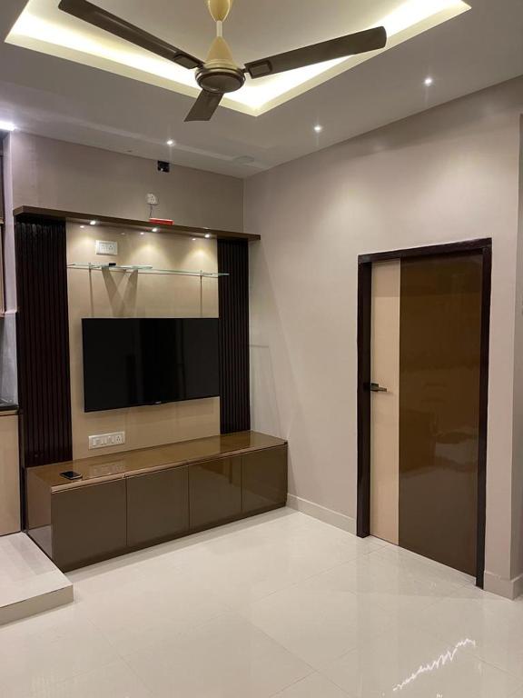 a living room with a flat screen tv on a wall at AVVAIRAM SERVICE APARTMENT G8 in Chennai