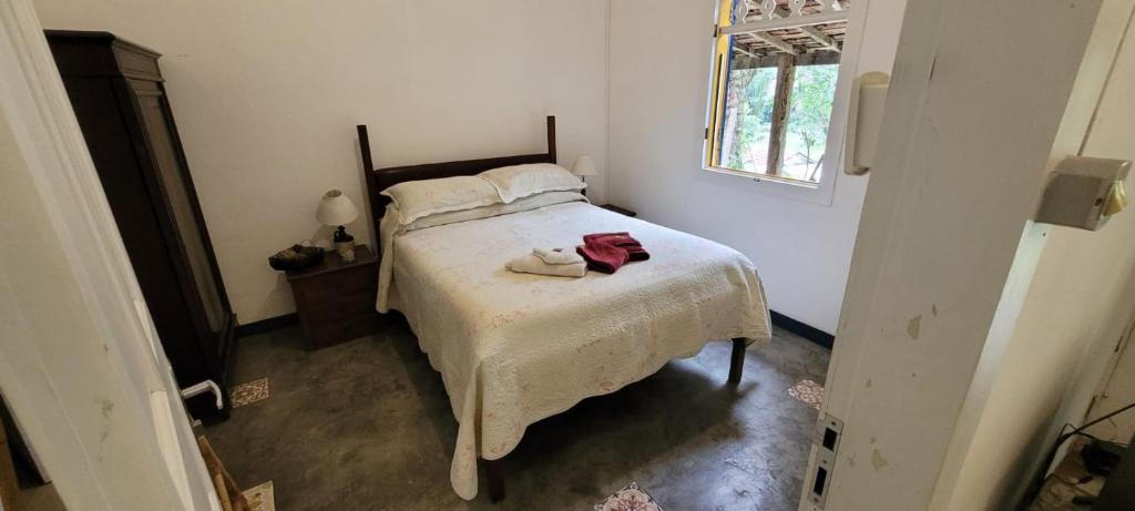 een slaapkamer met een bed met twee handdoeken erop bij Pouso Donana Cama e Café in Itaipava