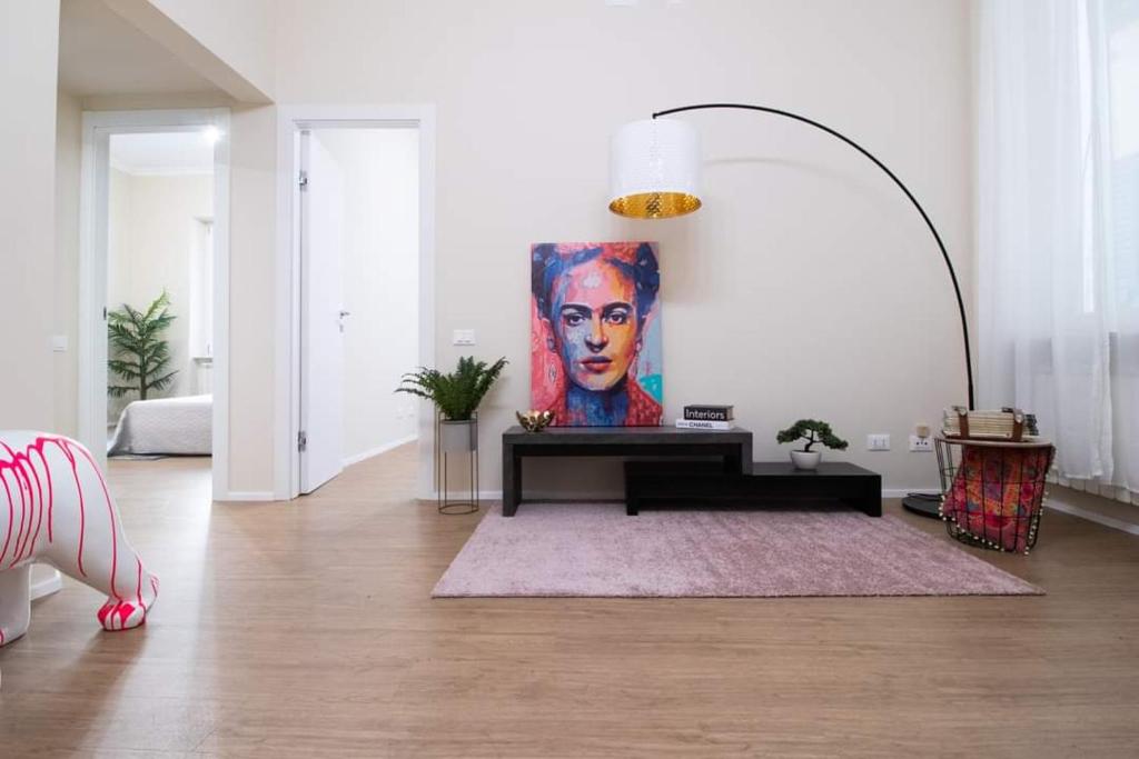 a living room with a painting of a woman at My Sweet Home in Genoa