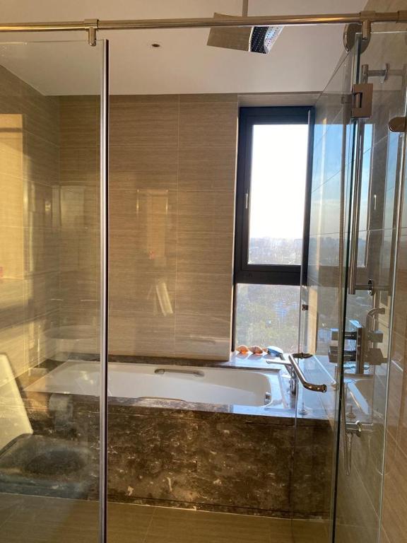 a bathroom with a bath tub and a window at two bedroom in Westland in Nairobi