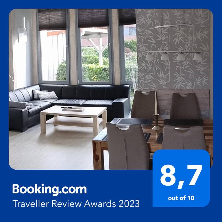 a living room with a couch and a table and chairs at FeWo an der Ostsee Nr. 2 in Rerik