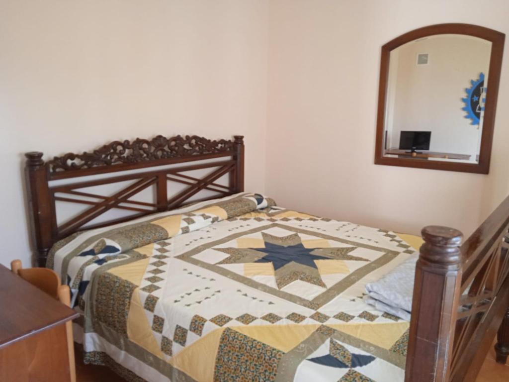 a bedroom with a bed with a quilt on it at Villa Imperia in Imperia