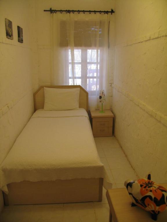 A bed or beds in a room at Pasha Apart Hotel