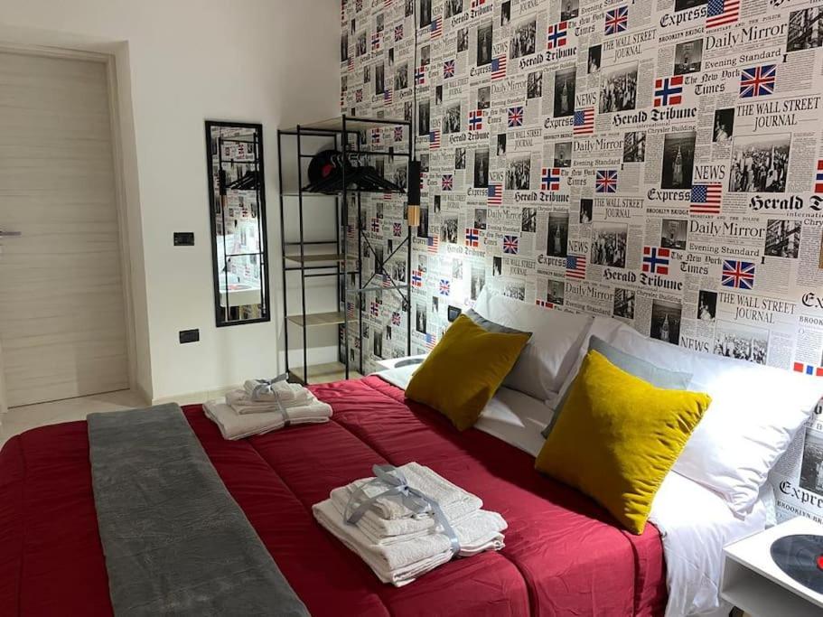 a bedroom with a large bed with towels on it at Pontecorvo Naples Apartament in Naples