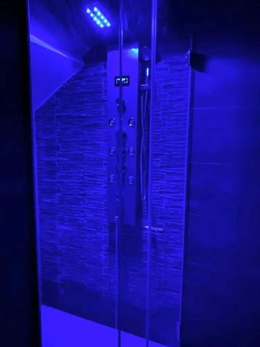a glass shower in a room with a brick wall at Pontecorvo Naples Apartament in Naples