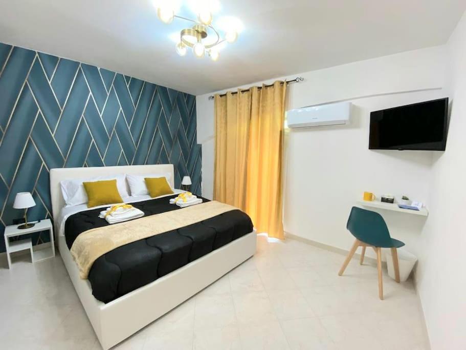 a bedroom with a bed and a tv in it at Pontecorvo Naples Apartament in Naples