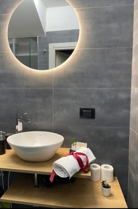 a bathroom with a white sink and a mirror at Pontecorvo Naples Apartament in Naples