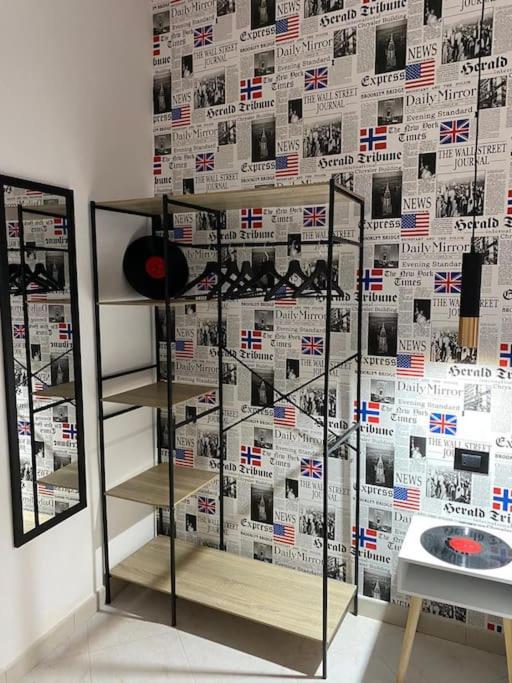a book shelf in front of a wall with american flags at Pontecorvo Naples Apartament in Naples