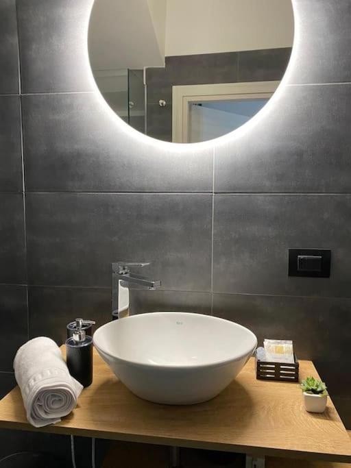 a bathroom with a white sink and a mirror at Pontecorvo Naples Apartament in Naples