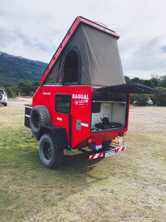 a red jeep with a tent on the back at BAGUAL TRAILER in Ushuaia