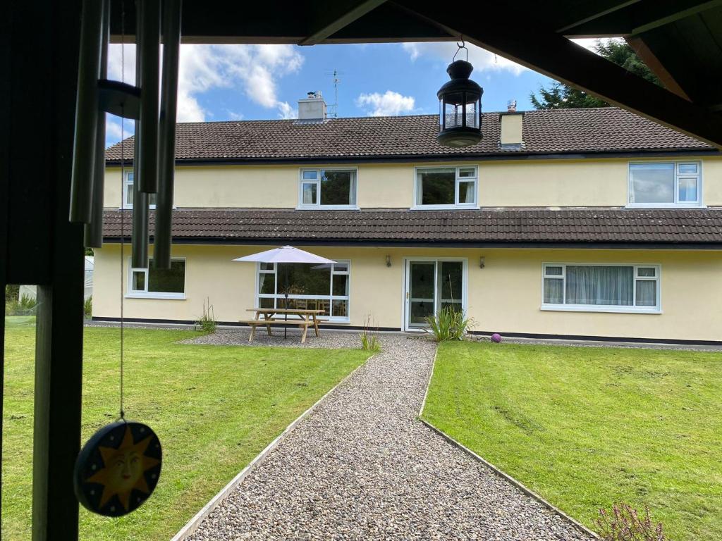 a house with a yard with a swing at Dove House in Killala