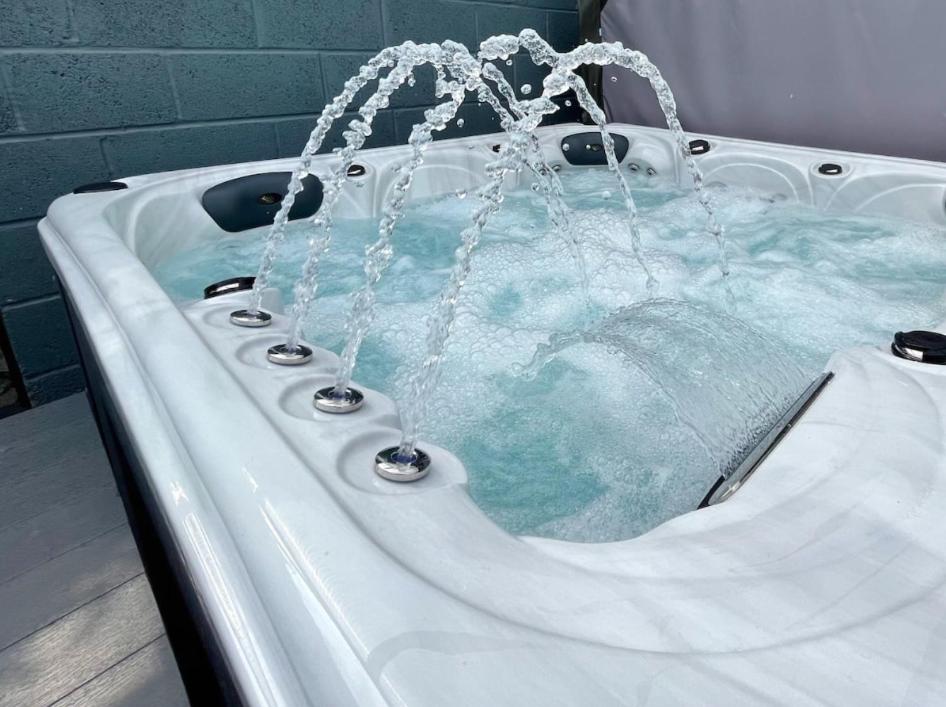 a bath tub with blue water in it at The Holiday Hoose in Kinghorn