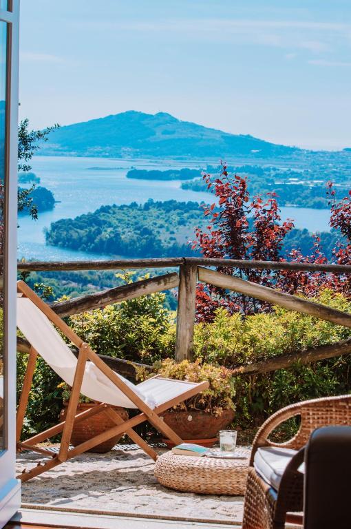a chair sitting on a porch with a view at Just like Home - Number 8 em Quinta das Mineirinhas in Vila Nova de Cerveira