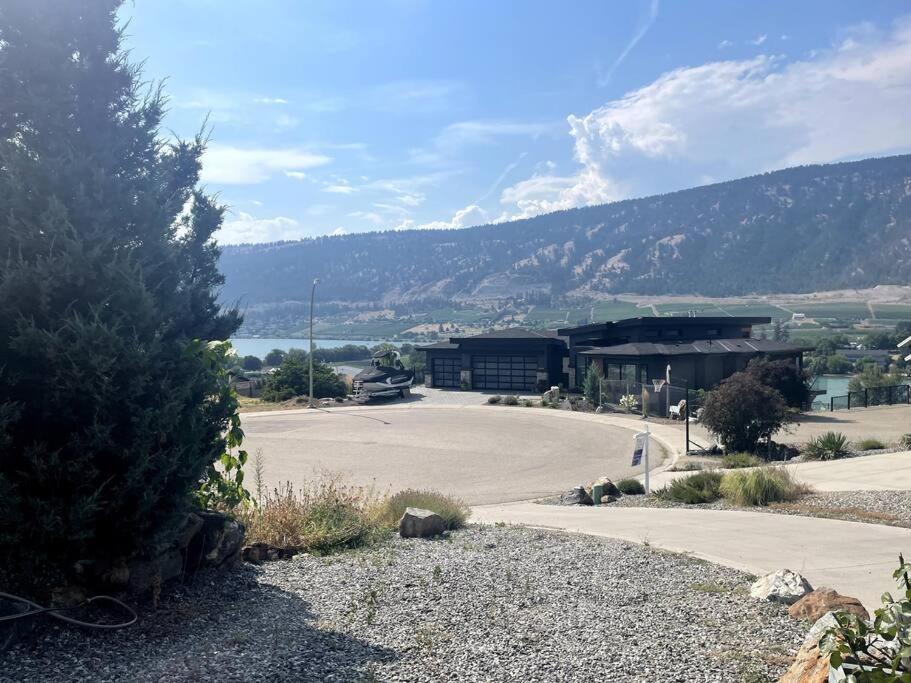 an empty parking lot with a building in the background at Oyama house- close to beach in Lake Country