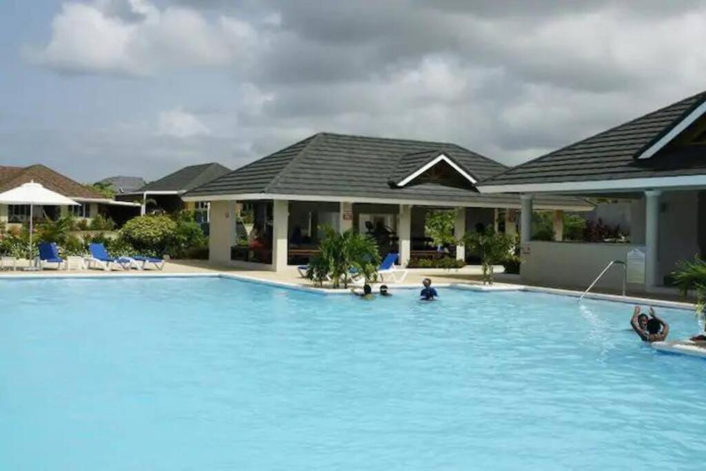 a swimming pool in front of a house at Sunset Palms by Richmond Estate in Richmond