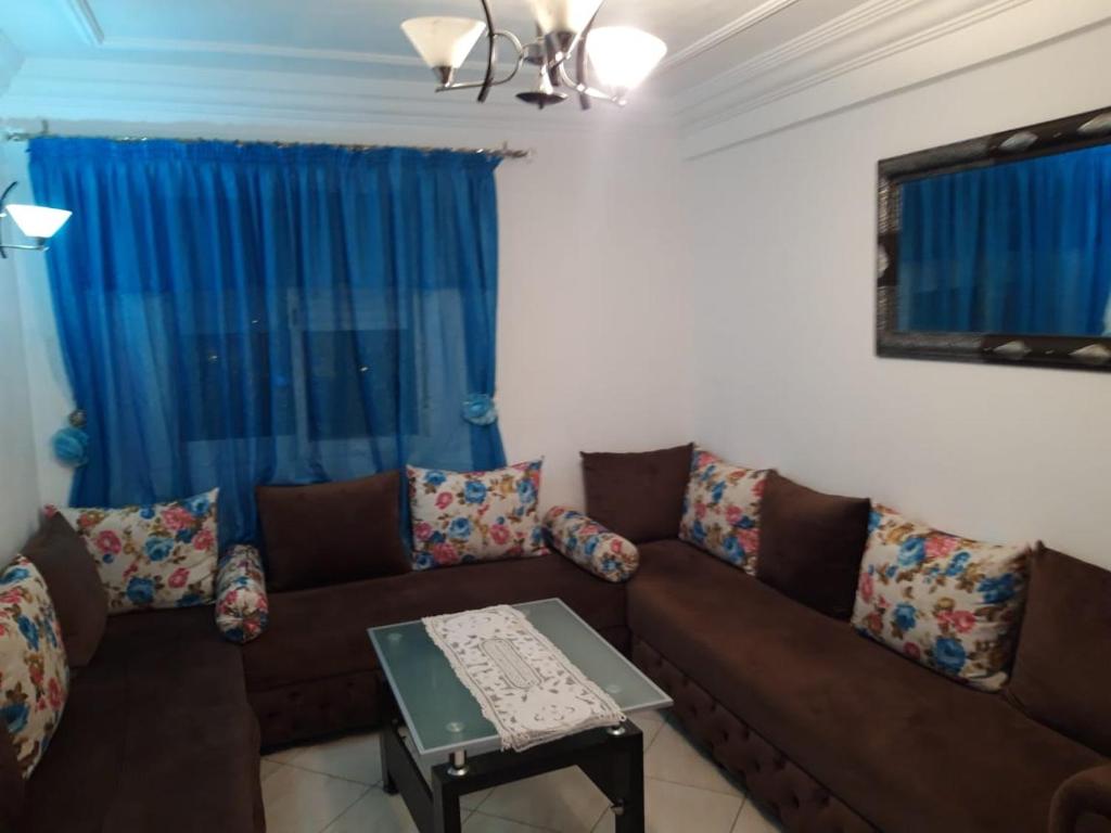 a living room with a couch and a table at Appartement Adrar in Agadir