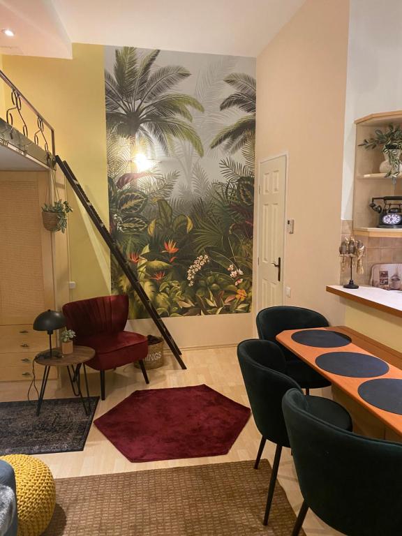 a room with a table and chairs and a mural at Jungle Story Apartment by Millenaris Park with Free Parking in Budapest