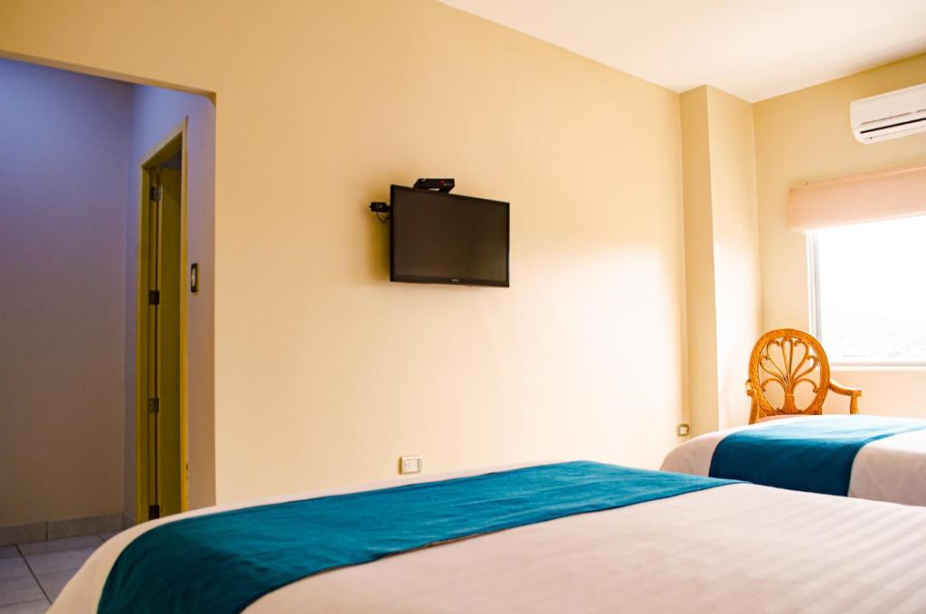 Postel nebo postele na pokoji v ubytování Hotel Ceibo Dorado