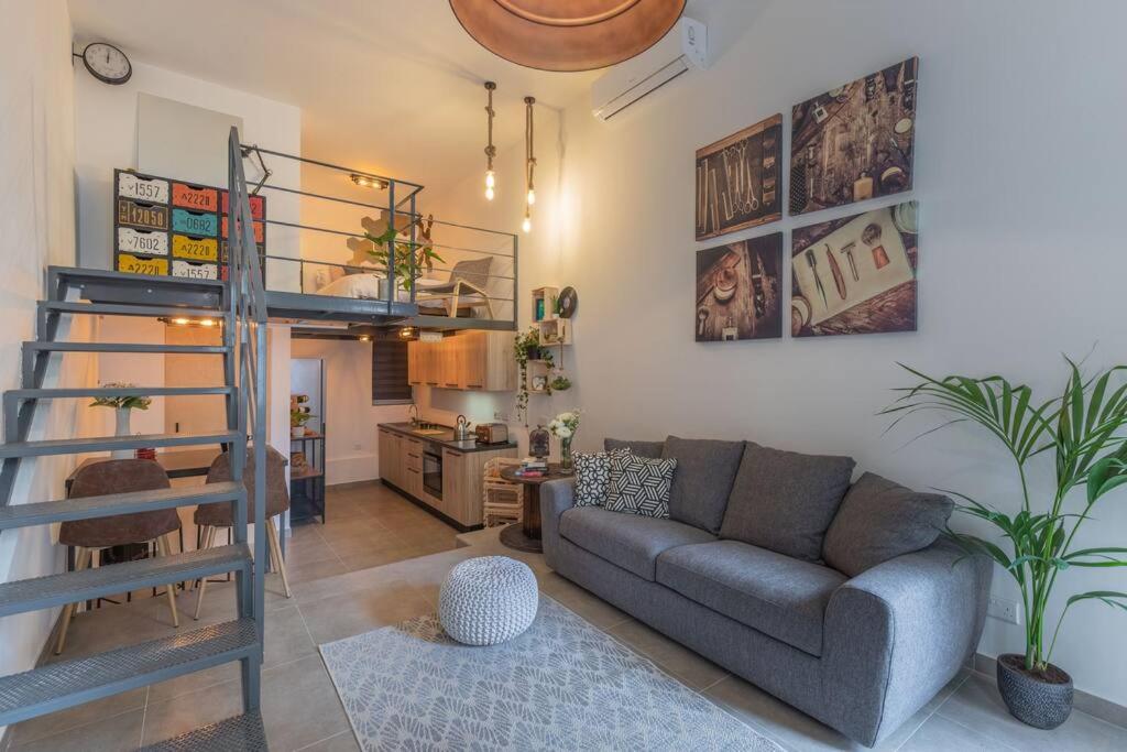 a living room with a couch and a bunk bed at Unique studio loft, walking distance to Valletta in Hamrun