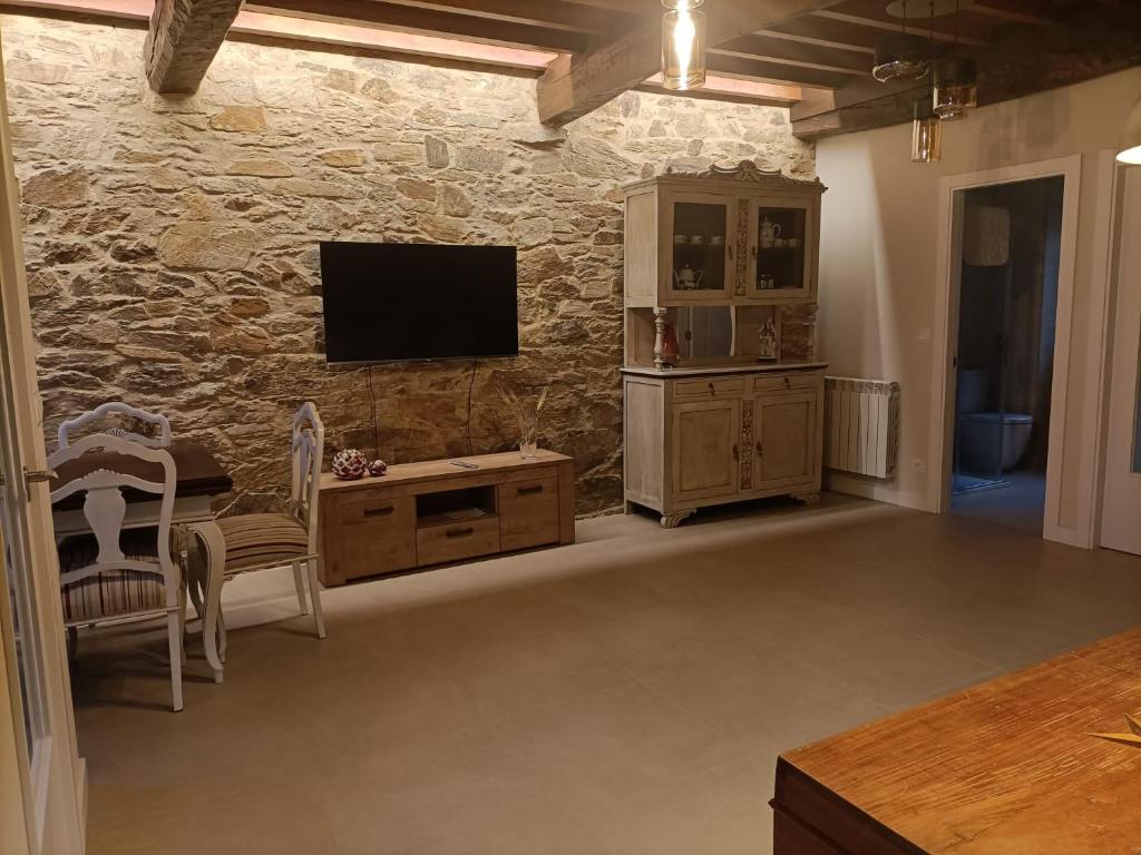 Televízia a/alebo spoločenská miestnosť v ubytovaní Casa a Antiga Tenda
