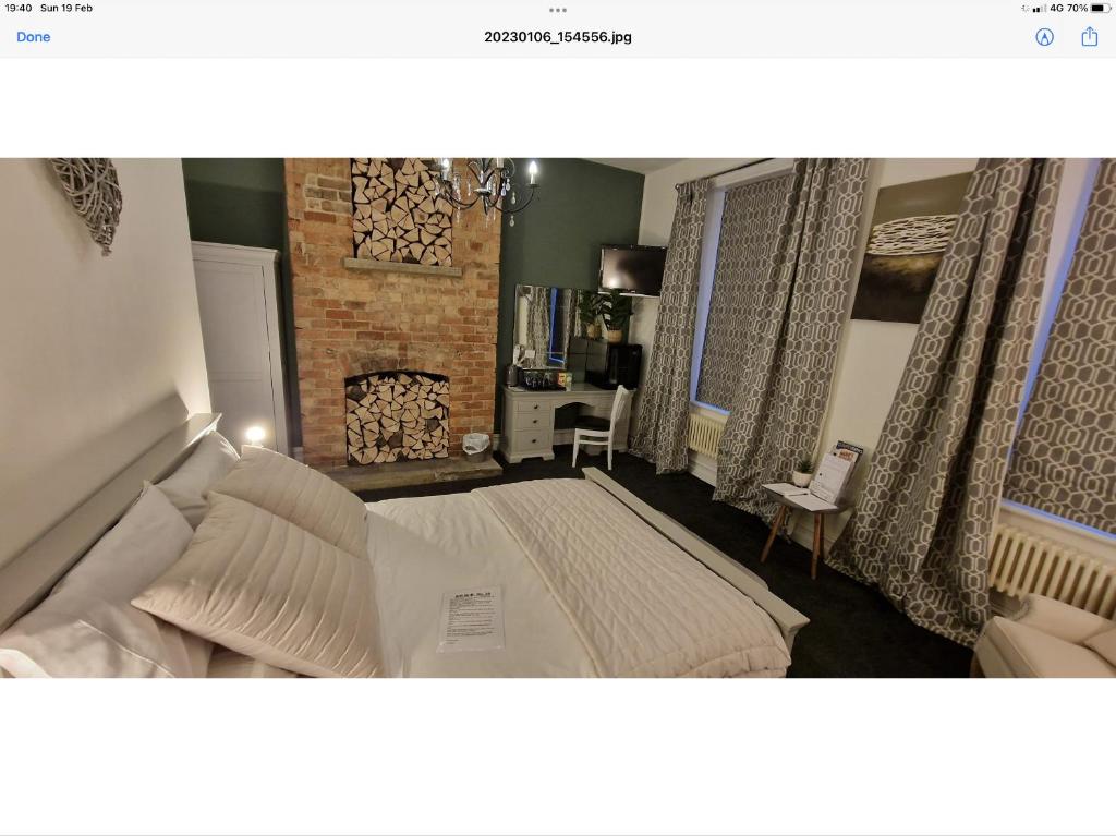 una camera con un grande letto e un camino di Beautiful apartment in Sleaford a Sleaford